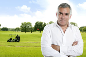 Golf senior golfer man portrait in green course outdoor